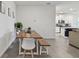 Open dining area next to kitchen, featuring a rustic table with seating and a view of the modern kitchen at 12517 Nantahala Run, Parrish, FL 34219
