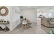 Open dining area with modern tile flooring, a wooden table, and kitchen view at 12517 Nantahala Run, Parrish, FL 34219