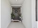 Welcoming home entrance featuring a decorative door, plants, and a 'Home Sweet Home' mat at 12517 Nantahala Run, Parrish, FL 34219