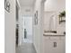 Hallway leading to a full bath featuring a granite countertop and stylish decor at 12517 Nantahala Run, Parrish, FL 34219