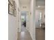 Hallway with neutral walls, tiled floors, and decorative artwork at 12517 Nantahala Run, Parrish, FL 34219