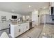 Open-concept kitchen with island, stainless steel appliances, and a view into the adjacent living spaces for easy entertaining at 12517 Nantahala Run, Parrish, FL 34219
