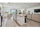 Bright, open kitchen features an island, granite countertops, stainless steel appliances, and seamless flow to the living area at 12517 Nantahala Run, Parrish, FL 34219