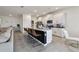 Open-concept kitchen with a large island, white cabinets, and modern appliances at 12517 Nantahala Run, Parrish, FL 34219