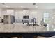 Bright kitchen featuring a large island with granite countertops, white cabinets, and stainless steel appliances at 12517 Nantahala Run, Parrish, FL 34219