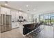 Modern kitchen with an island, stainless steel appliances, and view of a lake at 12517 Nantahala Run, Parrish, FL 34219