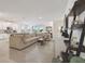 Bright living room with open floor plan to the kitchen and tile flooring at 12517 Nantahala Run, Parrish, FL 34219
