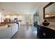 Open-concept living area with a large sofa, kitchen, and sliding glass doors at 12517 Nantahala Run, Parrish, FL 34219