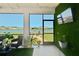 Relaxing screened in porch features outdoor furniture, a TV, and beautiful views of the lake at 12517 Nantahala Run, Parrish, FL 34219
