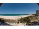 Expansive beach and oceanfront property with a pool, tennis court, and lush tropical landscaping at 1310 Gulf Blvd # 6C, Clearwater Beach, FL 33767