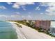 Stunning aerial view showcasing a beautiful beach next to condos and the ocean at 1310 Gulf Blvd # 6C, Clearwater Beach, FL 33767