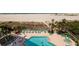 Aerial view of a sparkling pool and hot tub, surrounded by lounge chairs and manicured landscaping near the beach at 1310 Gulf Blvd # 6C, Clearwater Beach, FL 33767