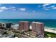 Aerial showcasing beachfront condos with tennis courts and a lovely coastal setting near the ocean at 1310 Gulf Blvd # 6C, Clearwater Beach, FL 33767