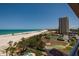 Stunning aerial perspective showcasing the beachfront location, tennis court, and beautifully maintained grounds at 1310 Gulf Blvd # 6C, Clearwater Beach, FL 33767