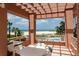 Balcony view showcasing the beachfront with palm trees and a refreshing community pool for a tropical lifestyle at 1310 Gulf Blvd # 6C, Clearwater Beach, FL 33767
