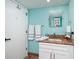 Well lit bath features a granite vanity, wood tile floors, and fresh towels and accessories at 1310 Gulf Blvd # 6C, Clearwater Beach, FL 33767