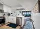 The updated kitchen features stainless steel appliances and is open to the living area and water views at 1310 Gulf Blvd # 6C, Clearwater Beach, FL 33767