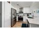 Updated kitchen with stainless steel appliances, modern lighting, and breakfast bar at 1310 Gulf Blvd # 6C, Clearwater Beach, FL 33767