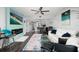 Open-concept living room with fireplace, modern furnishings, and adjacent kitchen at 1310 Gulf Blvd # 6C, Clearwater Beach, FL 33767