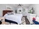 Bright bedroom featuring a ceiling fan, ocean-themed artwork, and ensuite bathroom access at 1310 Gulf Blvd # 6C, Clearwater Beach, FL 33767