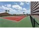 Well maintained outdoor tennis court offering a vibrant playing surface, set against a sunny sky at 1310 Gulf Blvd # 6C, Clearwater Beach, FL 33767