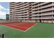 Outdoor tennis court positioned adjacent to high-rise condo, providing a scenic urban backdrop at 1310 Gulf Blvd # 6C, Clearwater Beach, FL 33767