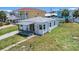 The home's charming exterior, features a covered porch, windows, and a well-maintained yard, perfect for curb appeal at 13124 4Th E St, Madeira Beach, FL 33708
