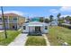 Charming single-story home featuring a cozy front porch and a classic white facade at 13124 4Th E St, Madeira Beach, FL 33708