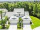 Aerial shot of residences featuring mature trees, manicured lawns, and a tranquil neighborhood atmosphere at 1624 Lullwater Ln, Lutz, FL 33549