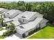 An aerial perspective of well-maintained homes surrounded by lush trees, offering a serene living environment at 1624 Lullwater Ln, Lutz, FL 33549