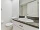 Bathroom with a white vanity, granite countertop, and a toilet at 1624 Lullwater Ln, Lutz, FL 33549