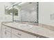 Dual sink bathroom featuring a decorative mirror, white cabinets and lots of counter space at 1624 Lullwater Ln, Lutz, FL 33549