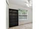 Bedroom featuring a window, ceiling fan, and a black bookcase at 1624 Lullwater Ln, Lutz, FL 33549