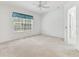 Spacious bedroom with a ceiling fan, neutral carpet and window with shade is bright and airy at 1624 Lullwater Ln, Lutz, FL 33549