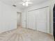 A bright bedroom with carpet and a large closet at 1624 Lullwater Ln, Lutz, FL 33549