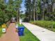 View of boat ramp, dock, and waterway with caution signs surrounded by trees at 1624 Lullwater Ln, Lutz, FL 33549