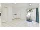 Dining area with tile floors, slider door to private patio, and utility closet at 1624 Lullwater Ln, Lutz, FL 33549