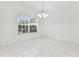 Dining area bathed in natural light, showcasing tile floors and a stylish chandelier at 1624 Lullwater Ln, Lutz, FL 33549