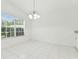 Bright dining area with a chandelier, large windows and tiled floor at 1624 Lullwater Ln, Lutz, FL 33549