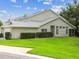 Well-maintained home featuring manicured lawn, hedges, and a screened-in porch for relaxing outdoor living at 1624 Lullwater Ln, Lutz, FL 33549
