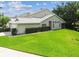 Charming home boasts a well-kept lawn, trimmed hedges, and an inviting screened-in porch for outdoor enjoyment at 1624 Lullwater Ln, Lutz, FL 33549