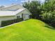 Exterior highlights include a tidy lawn, manicured hedges, and an inviting screened-in porch for leisure at 1624 Lullwater Ln, Lutz, FL 33549