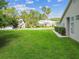 Exterior features a well-maintained lawn, green shrubs, and nearby palm trees in a peaceful neighborhood setting at 1624 Lullwater Ln, Lutz, FL 33549