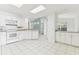 Bright kitchen featuring white cabinetry, tile floors, and stainless steel appliances at 1624 Lullwater Ln, Lutz, FL 33549