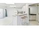 Open kitchen area with breakfast bar, tile floors, and access to a bathroom and living area at 1624 Lullwater Ln, Lutz, FL 33549