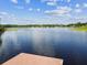 Scenic view of a lake with reflections of the sky, surrounded by green vegetation and trees at 1624 Lullwater Ln, Lutz, FL 33549