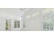 Bright, airy living room with large windows, high ceilings, and a glass door to the outside at 1624 Lullwater Ln, Lutz, FL 33549