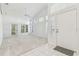 Bright living room with high ceilings, white walls, large windows and ceramic tile entryway at 1624 Lullwater Ln, Lutz, FL 33549