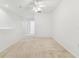 Upstairs loft with neutral carpet features natural light from windows and a ceiling fan at 1624 Lullwater Ln, Lutz, FL 33549
