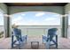 Cozy balcony overlooking the water, with seating for two and coastal charm at 16365 Redington Dr, Redington Beach, FL 33708